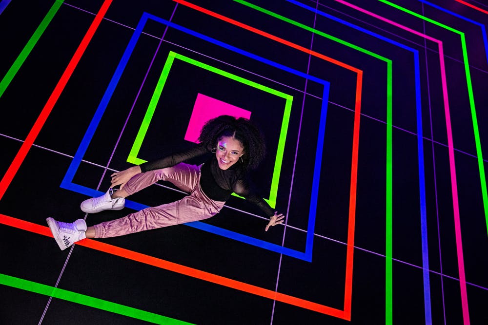 Girl Sits in Middle of Colorful Neon Square Dance Floor | PartySlate