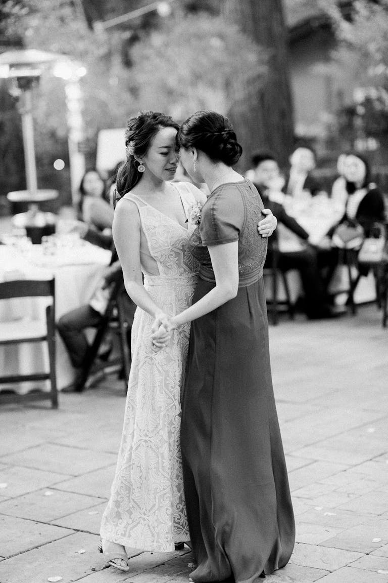 Mother and bride slow dance during wedding reception.