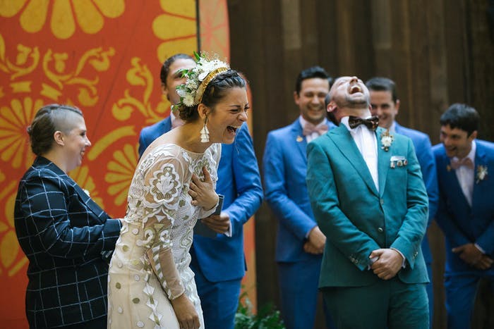 A couple at the end of the aisle bending over in laughter