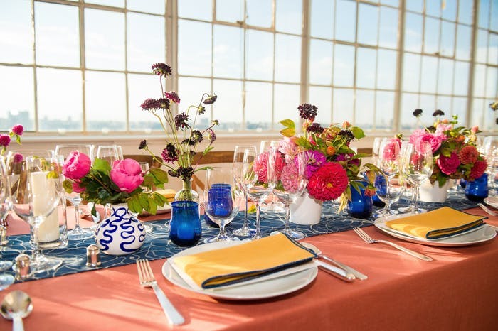 Colorful tablescape with massive paned windows behind.