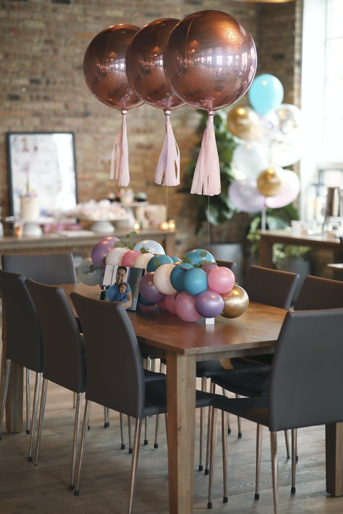 a table with colorful balloons with tassels