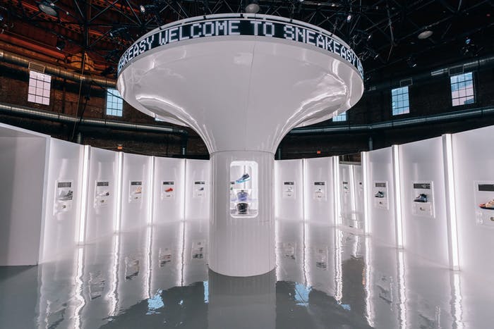 A circular room with white lockers around the outside and a large mushroom shaped middle structure