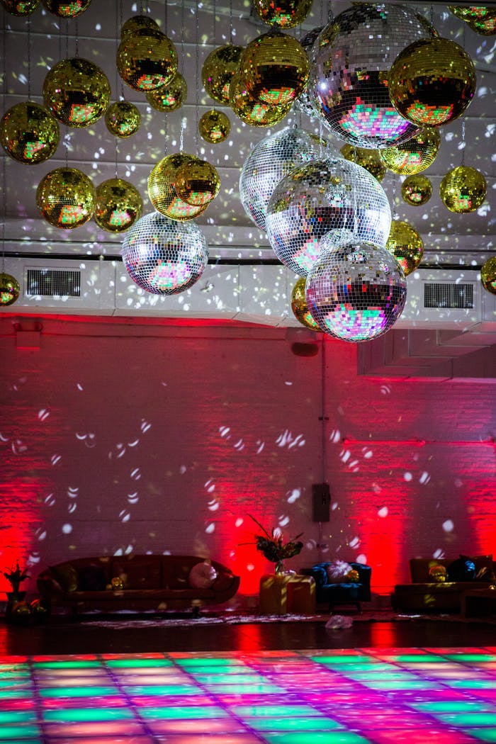Disco-Themed Party With Disco Ball Ceiling Installation and Colorful LED Dance Floor | PartySlate