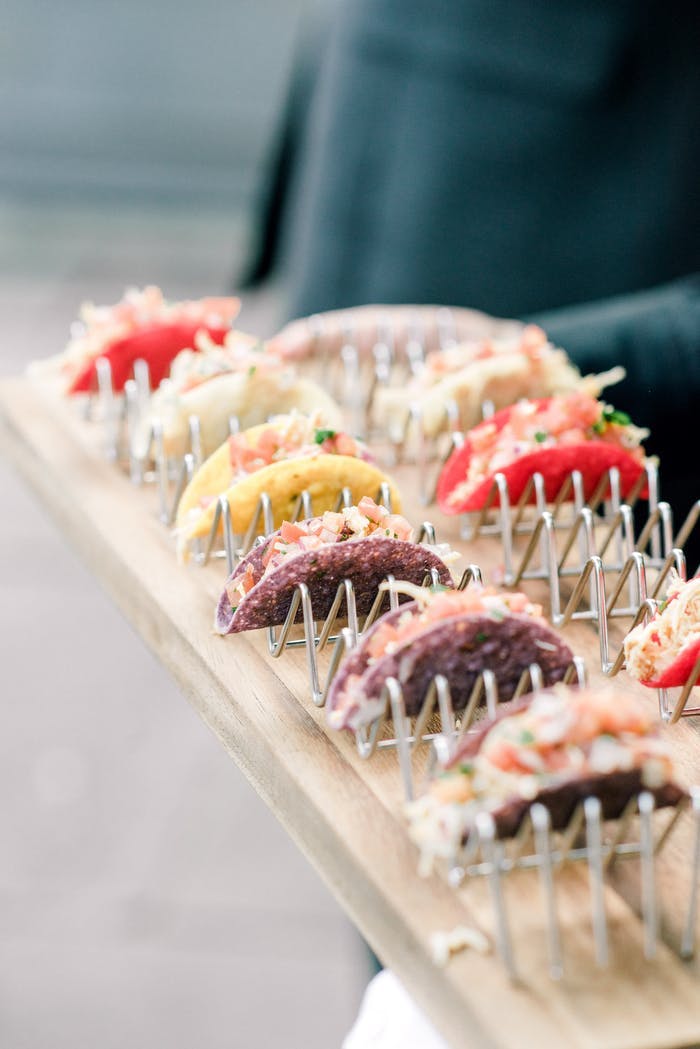 mini tacos in their stands on an appetizer tray