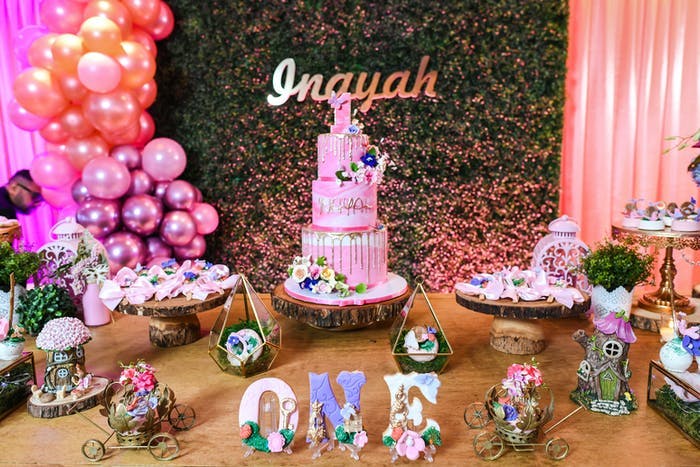A dessert table covered sweets and cookies spelling out 