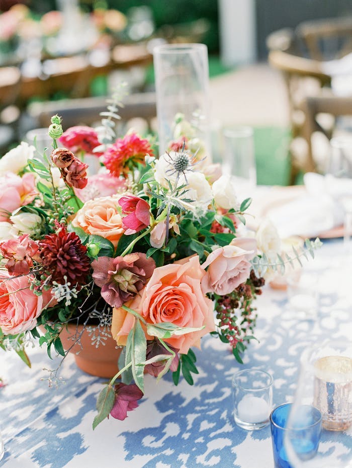Colorful floral arrangement with blue and white patterned linen