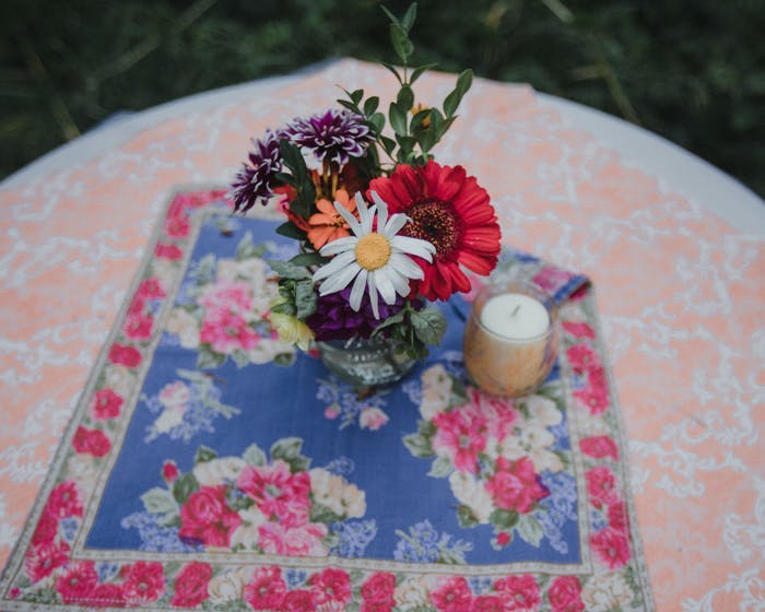 minimal flower arrangement on two patterned table linens