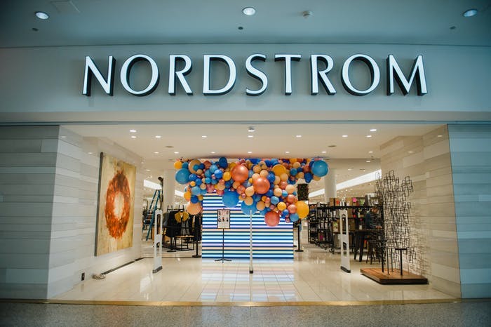 an entrance to a Nordstrom with balloons