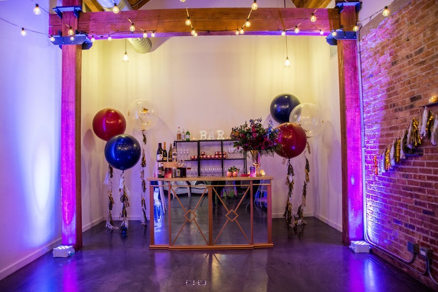 An entrance table with balloons on either side