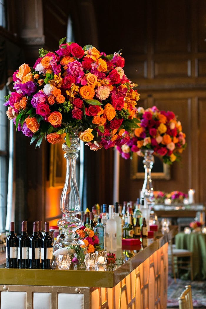 tall transparent vases with red, pink and orange florals