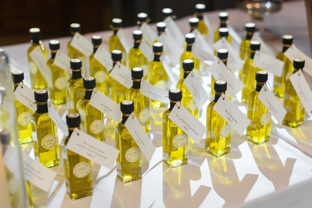 Wedding party favors of mini bottles of olive oil.