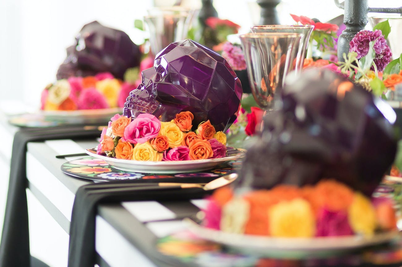 Halloween-themed corporate dinner party with purple skull decorations.