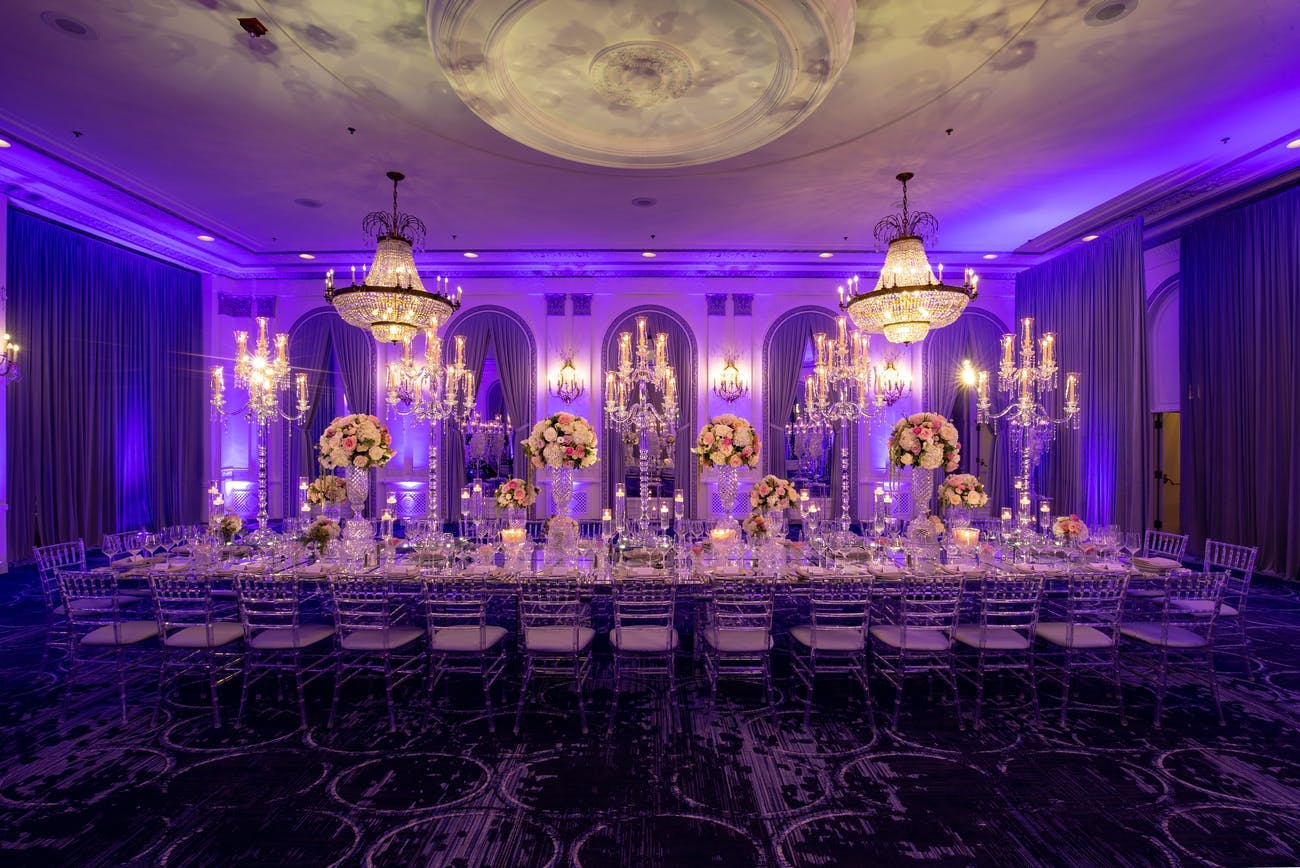 Corporate dinner party at ballroom with dramatic purple mood lighting | PartySlate