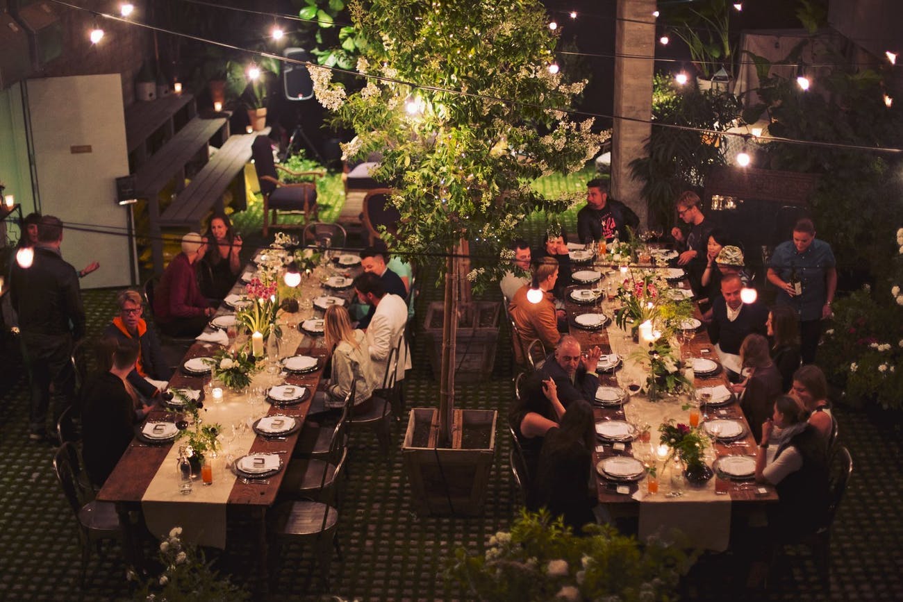 Greenery ceiling decor with candle lighting at corporate event | PartySlate