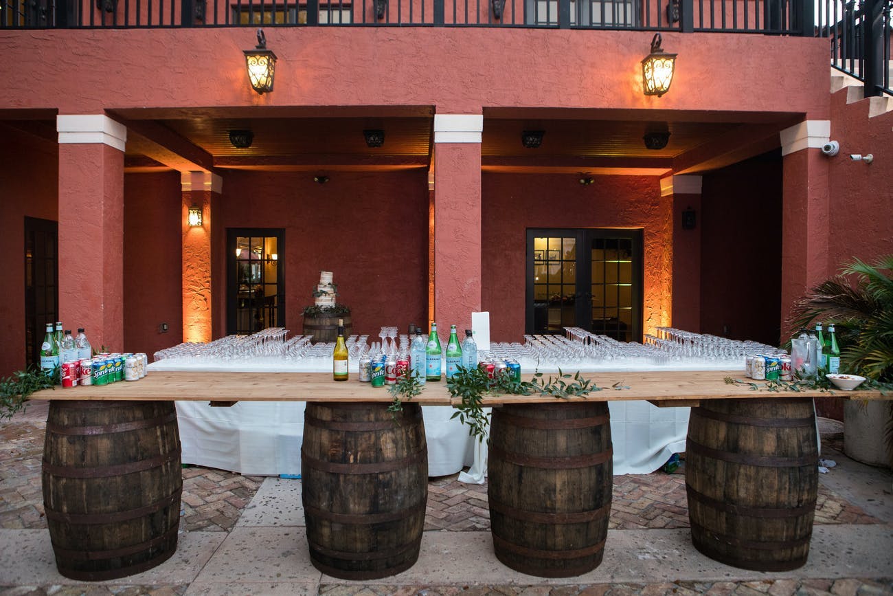 Rustic wedding bar set up with wine barrels.
