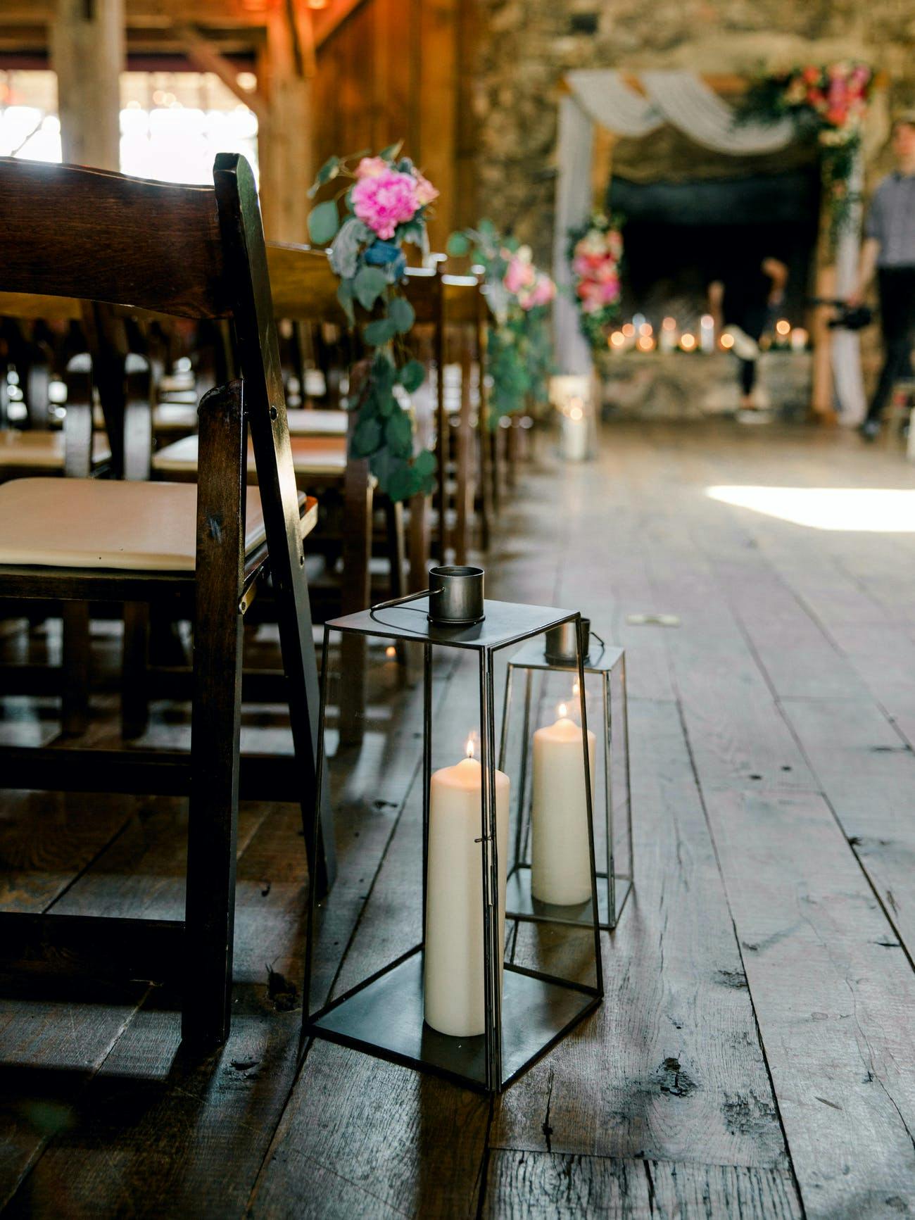 Rustic wedding ceremony with lantern aisle décor.