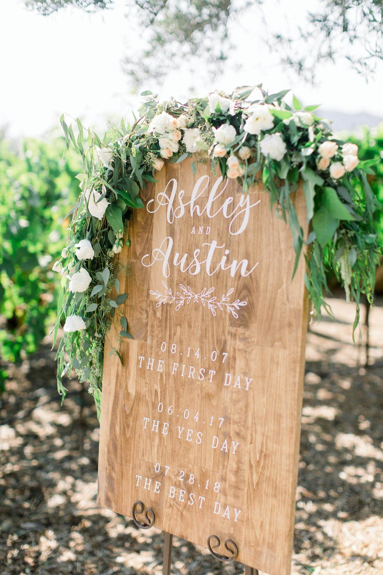 Rustic wedding signage with florals | PartySlate