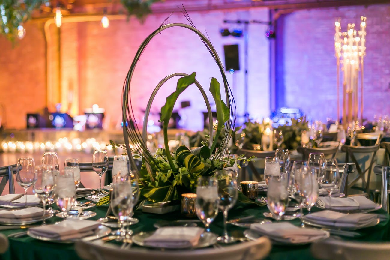 Concentric rings of gold wiring mirror the natural sweep of delicate greenery in this modern, industrial centerpiece.