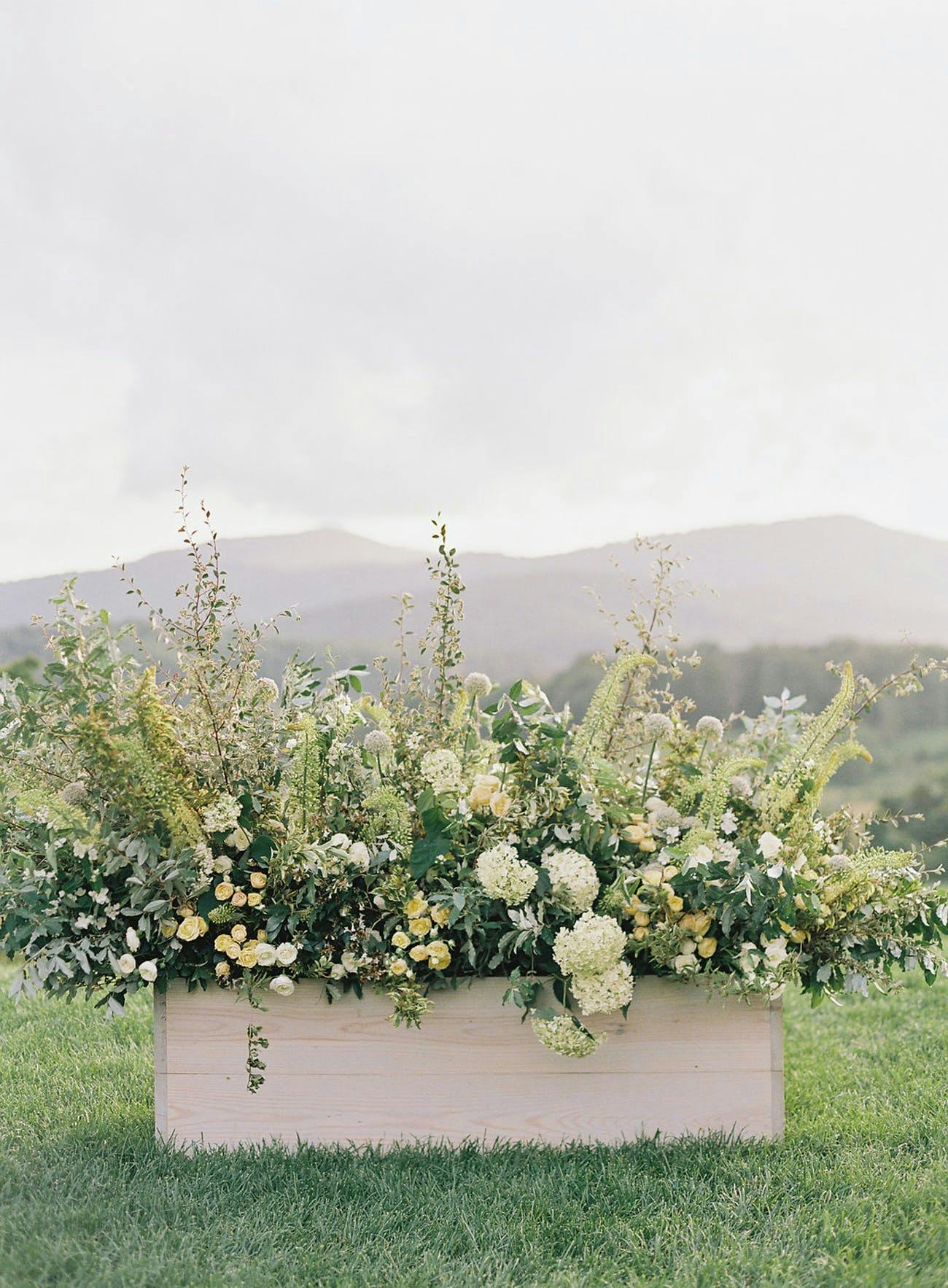 Rustic wedding planter with mountain backdrop | PartySlate