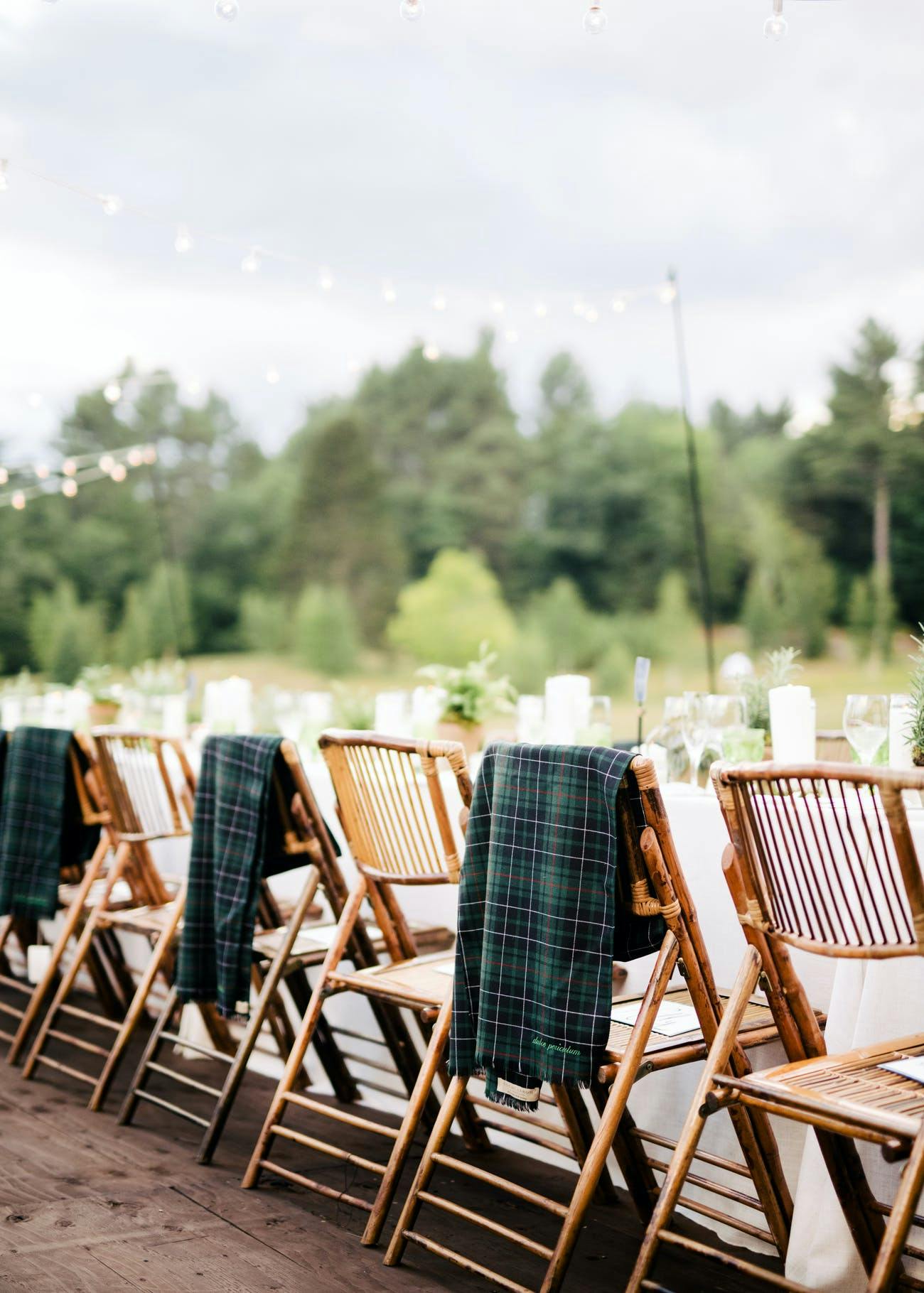 Wedding reception table seating with flannel throw blankets.