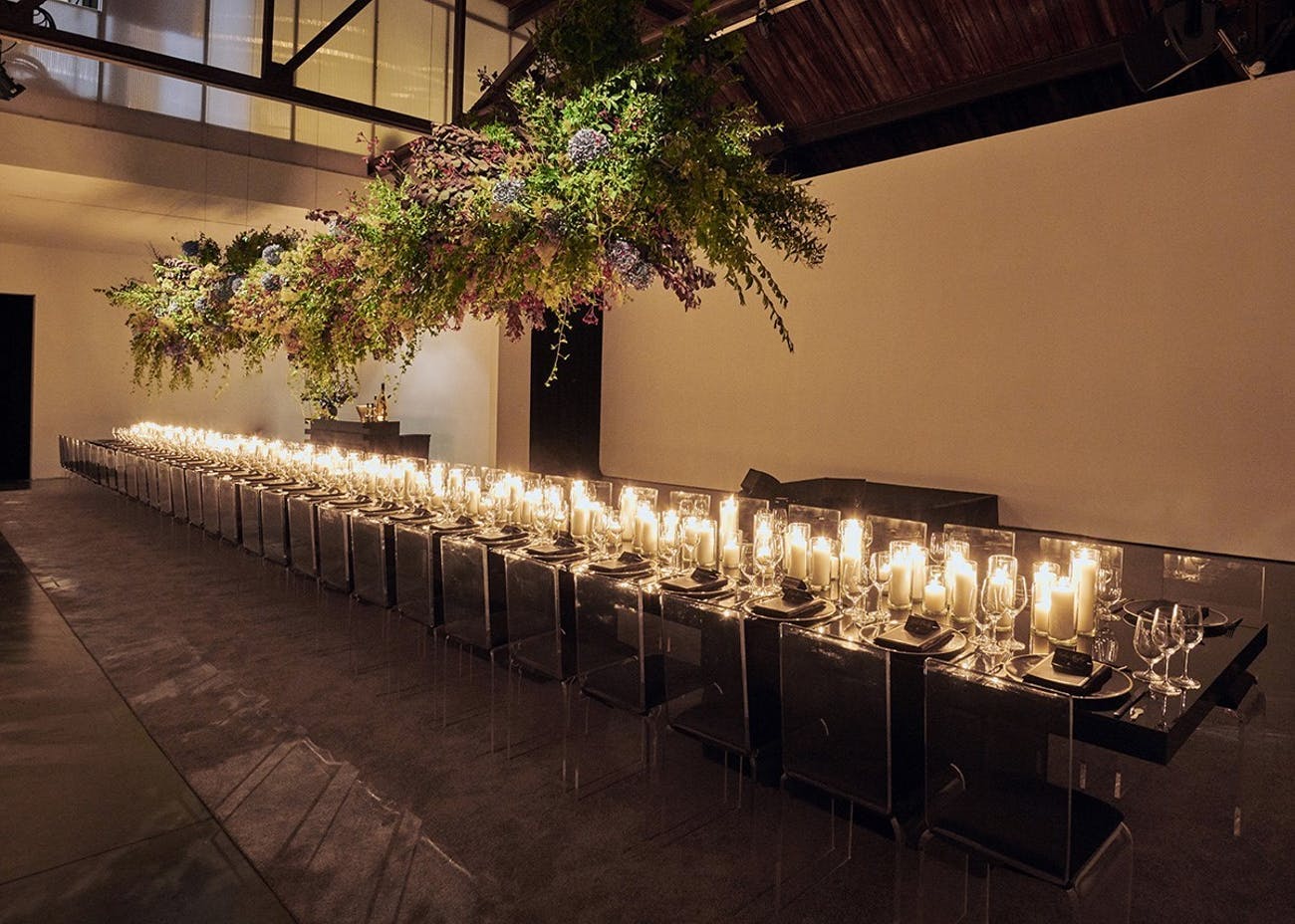 Candlelit corporate dinner party in modern studio space | PartySlate