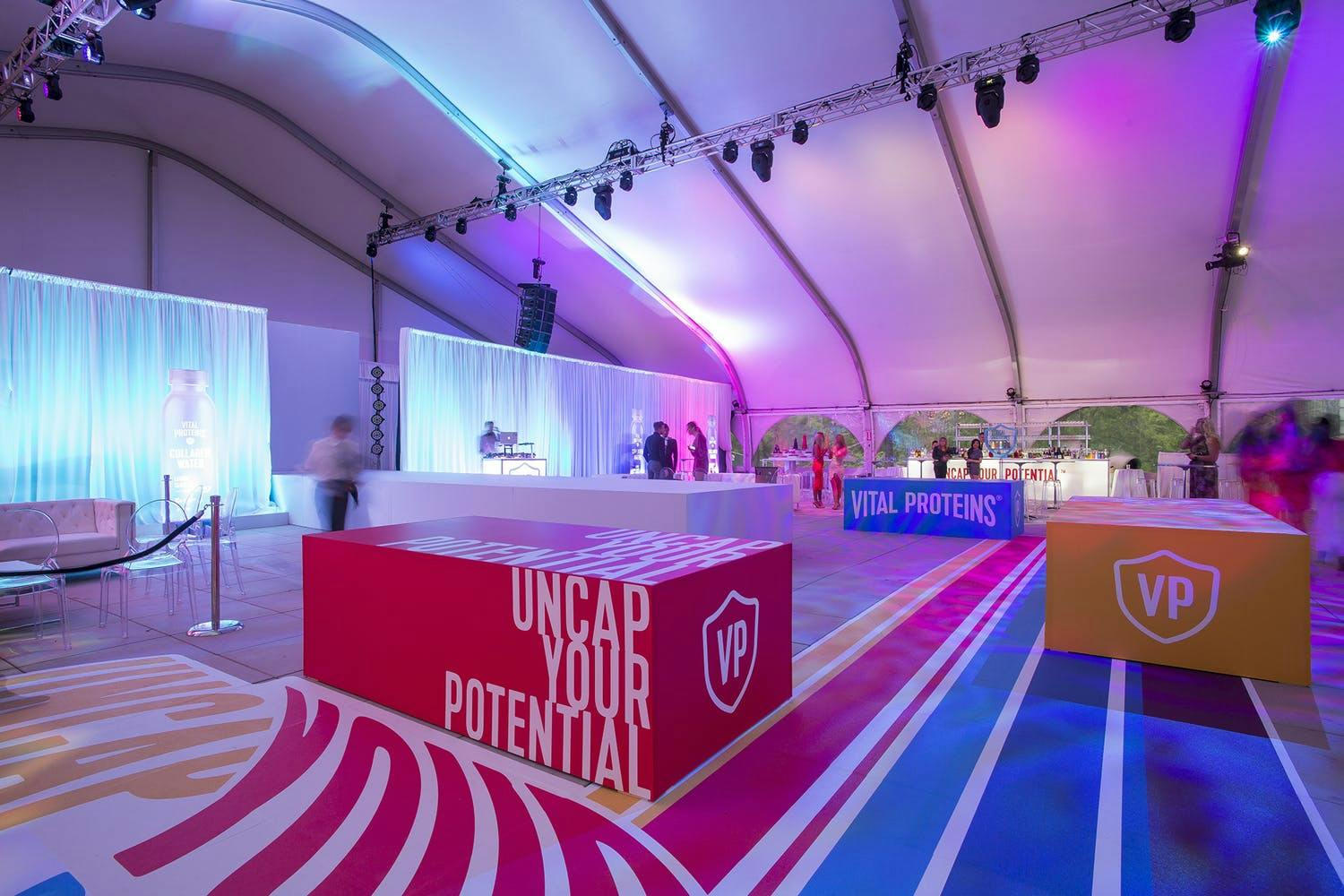Tented space with colorful and geometric "VP" branding.