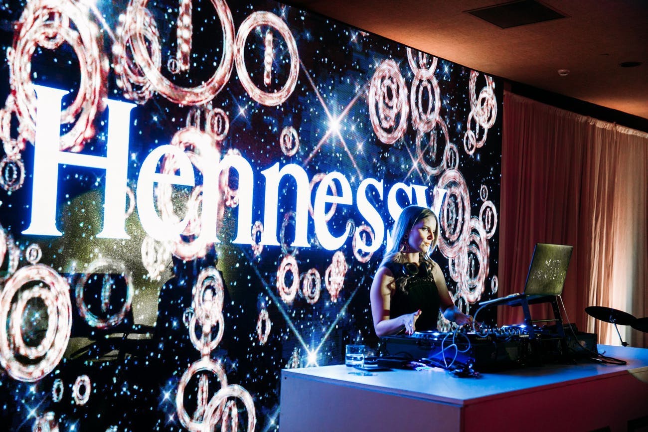 Hennessy corporate dinner party with DJ and branded décor.
