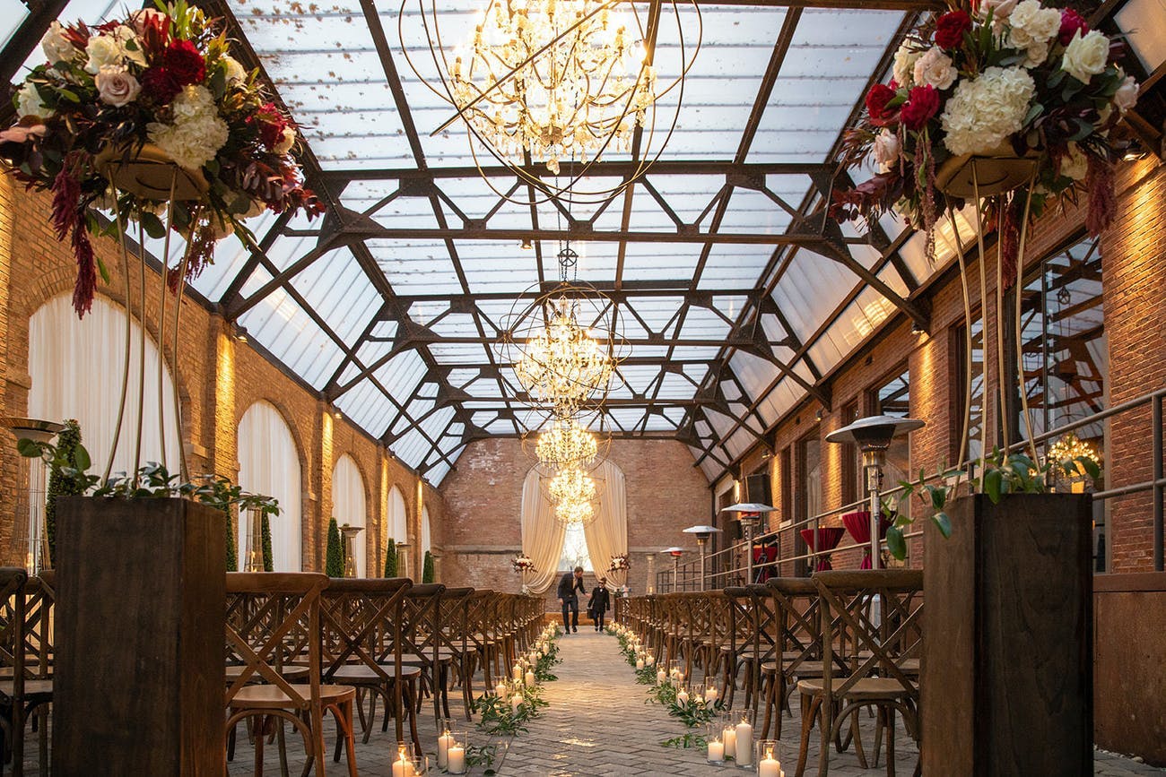 Rustic wedding ceremony with wire-wound chandeliers.