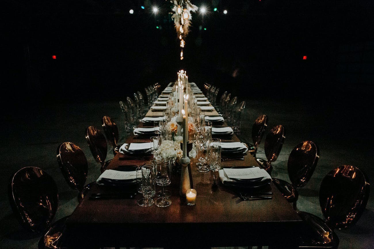 Corporate dinner party in the dark at warehouse space.