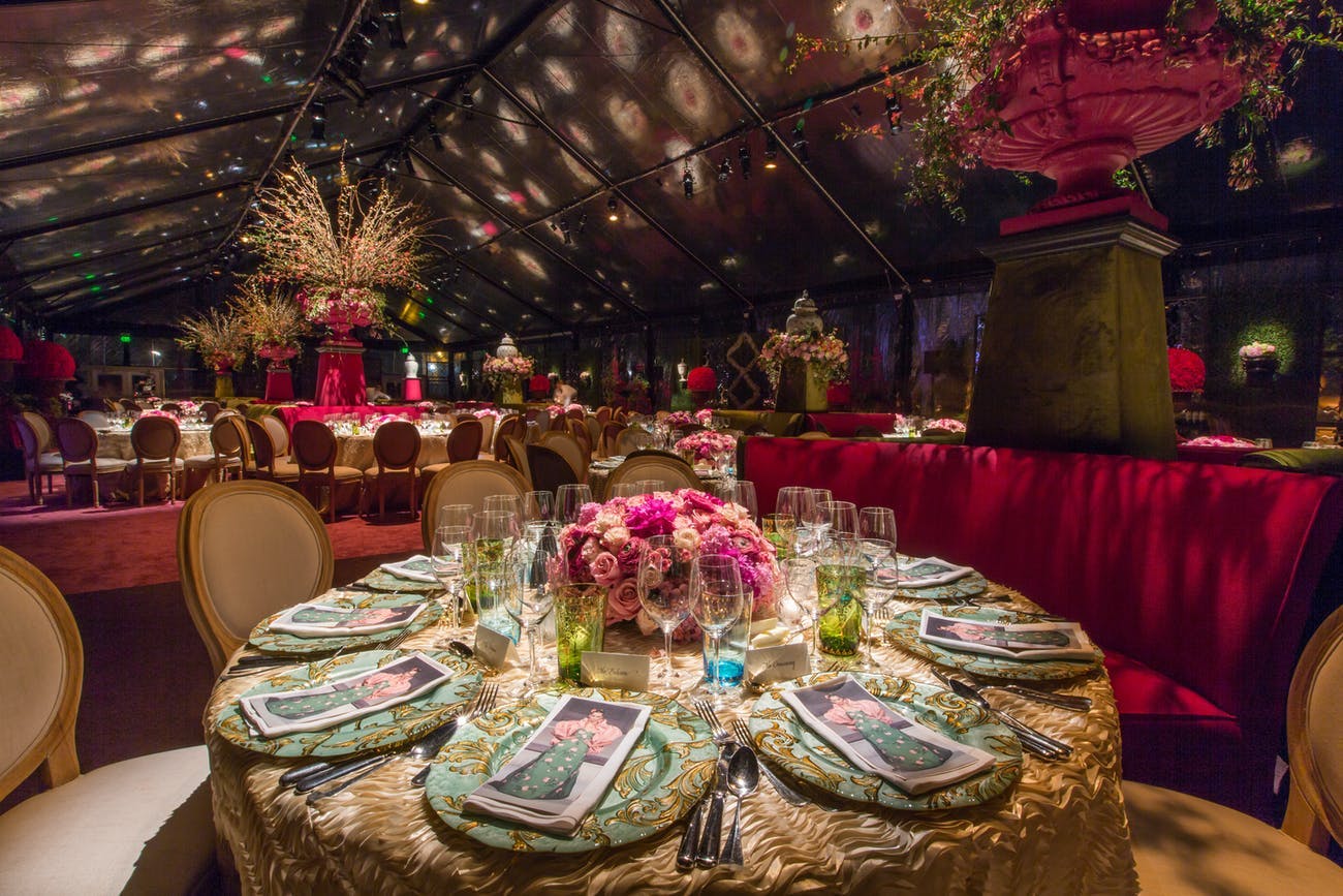 dramatic light installations with red accents ar Oscar de la Renta corporate dinner party | PartySlate