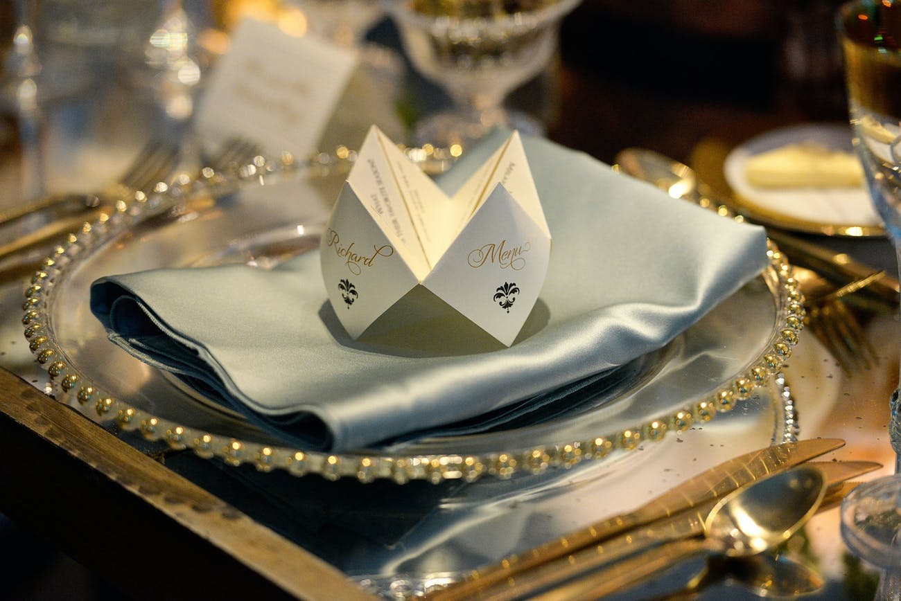 Clear Plates with Gold Embellishments and a Light Blue Napkin
