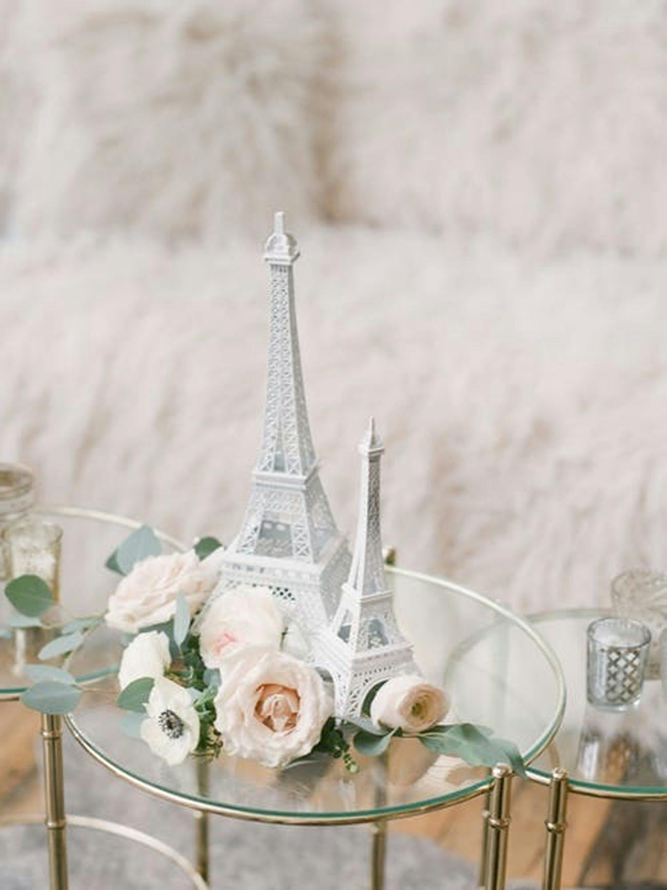 Tiny Clear Side Table with a Silver Eiffel Tower Surrounded with Flowers