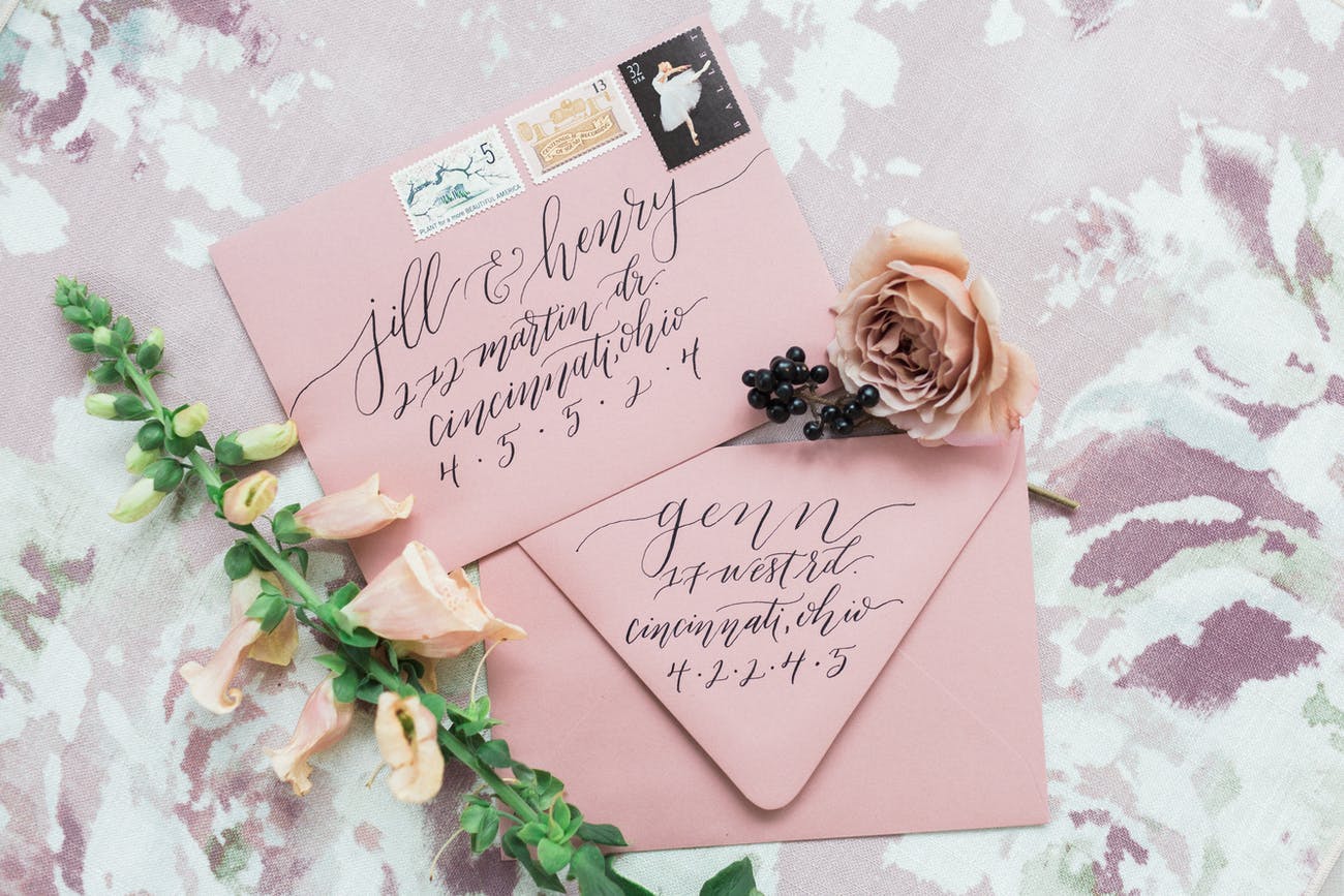 Pink Envelopes with Black Calligraphy and a Flower