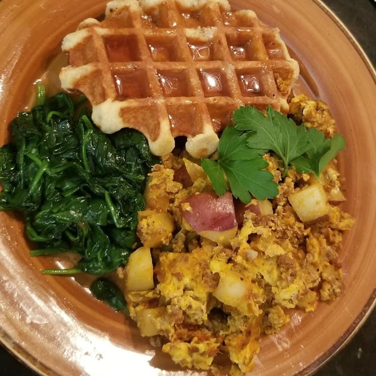 Catered waffle, collards, and potatoes.