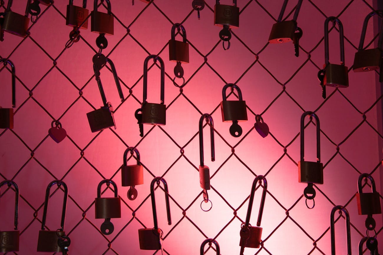 Fence Filled with Locks and Keys and a Hot Pink Backdrop