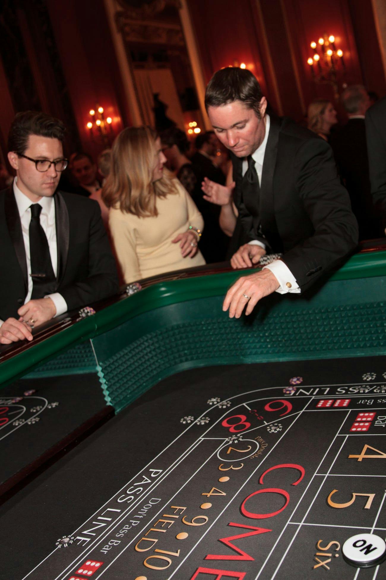Two Men Rolling Dice and Having a Good Time at a Casino Table