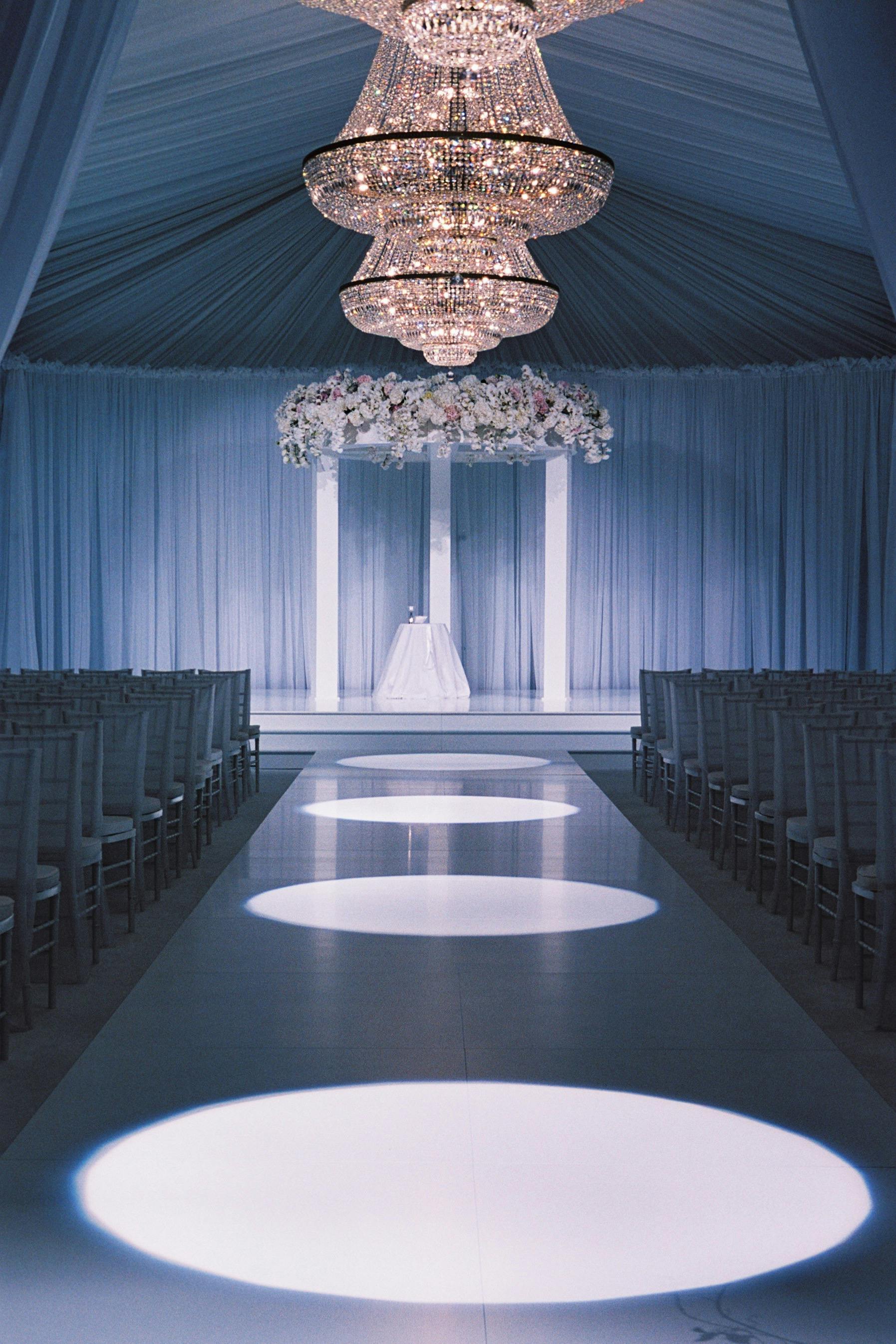 Stunning Tented Wedding with Unique Wedding Aisle Featuring Consecutive Spotlights | PartySlate