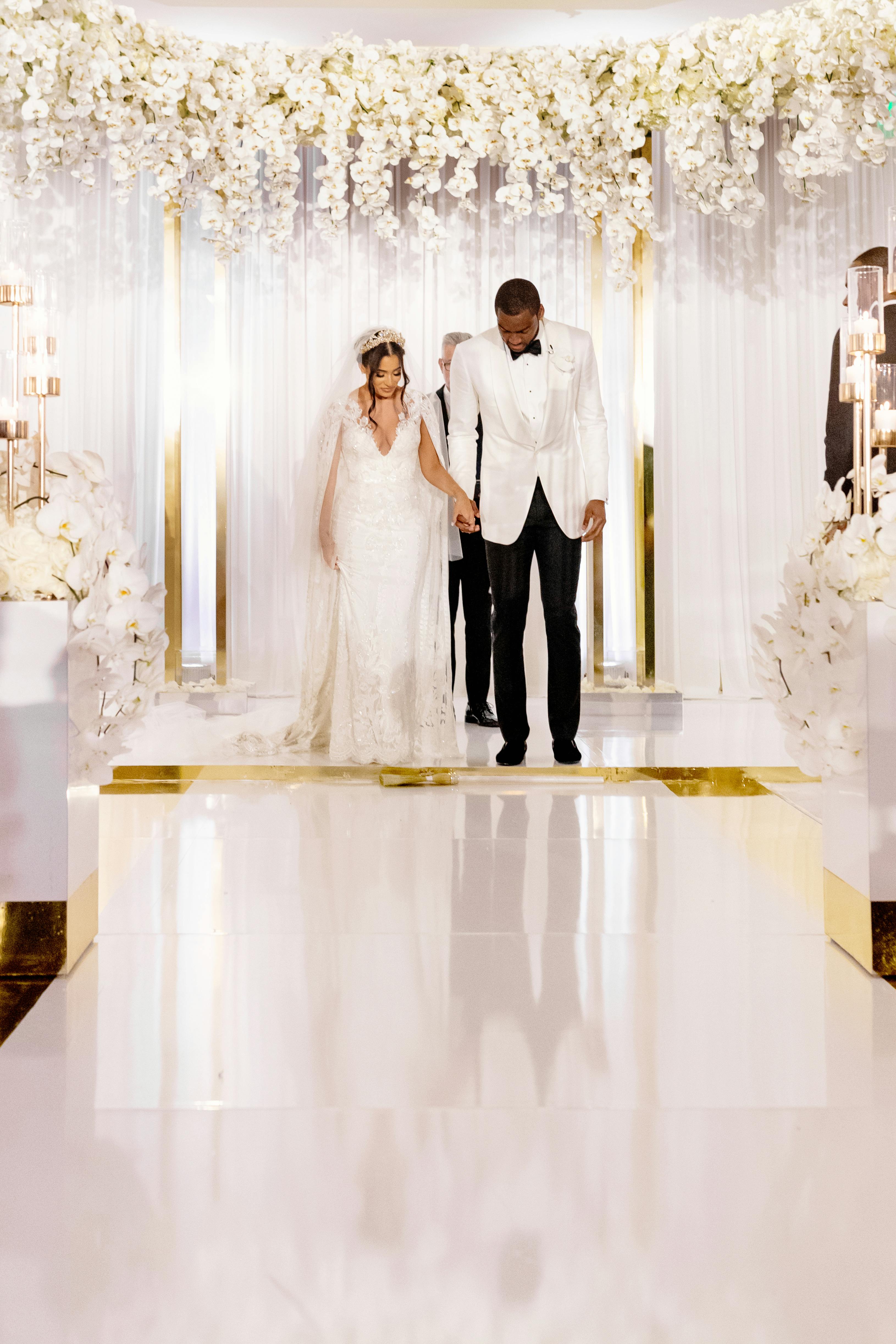 Textured White Layered Wedding at Four Seasons Hotel Miami with Mirrored Wedding Aisle | PartySlate