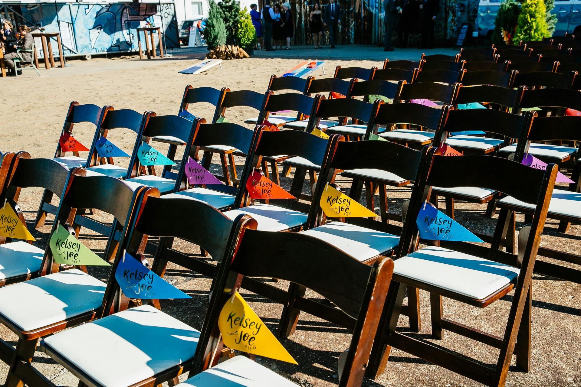 Wedding Ceremony Seating With Colorful Flags | PartySlate