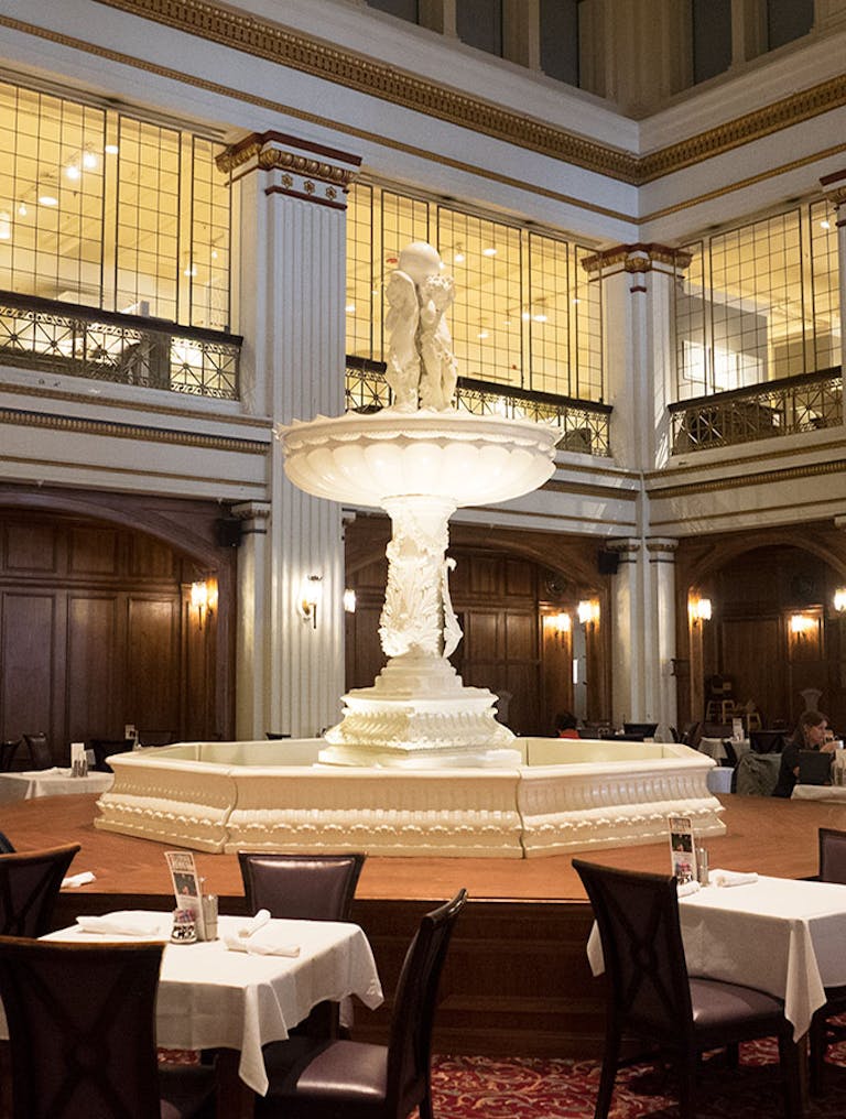 White stone fountain centers the room at the Walnut Room at Macy's in Chicago, IL | PartySlate