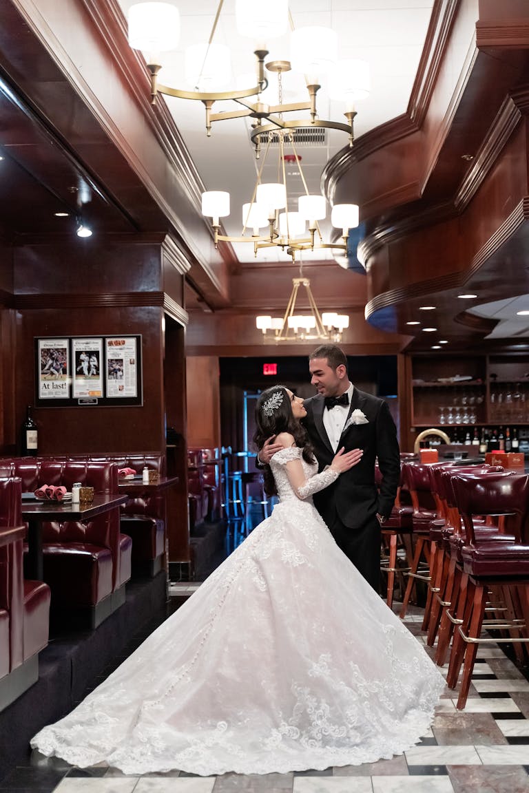 Bride and Groom Pose For Wedding Photos For A Stunning And Elegant Ceremony at The Estate by Gene and Georgetti in Chicago, IL | PartySlate