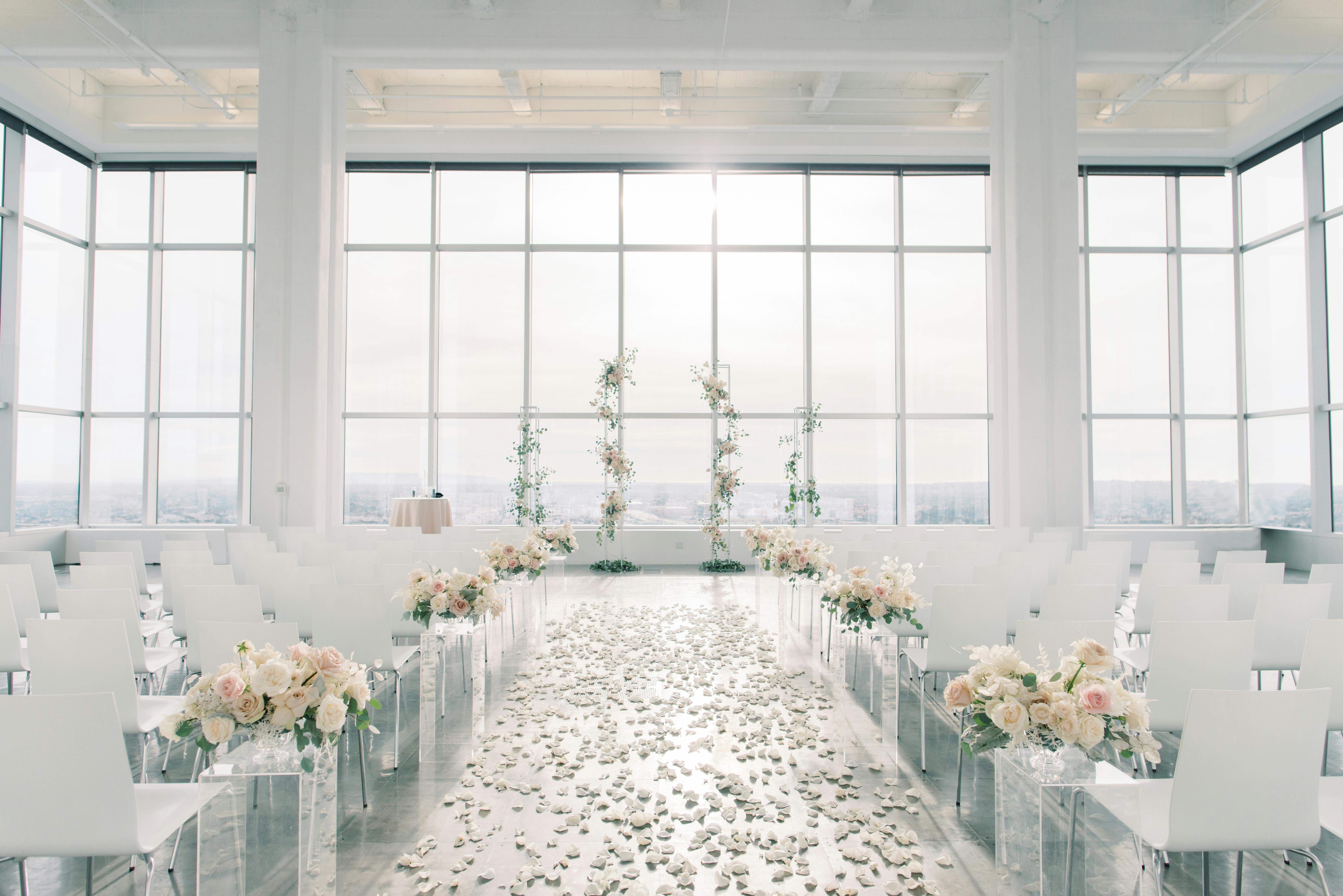 Bright White Wedding With Monochromatic Wedding Aisle Décor And Portrait Style Windows | PartySlate