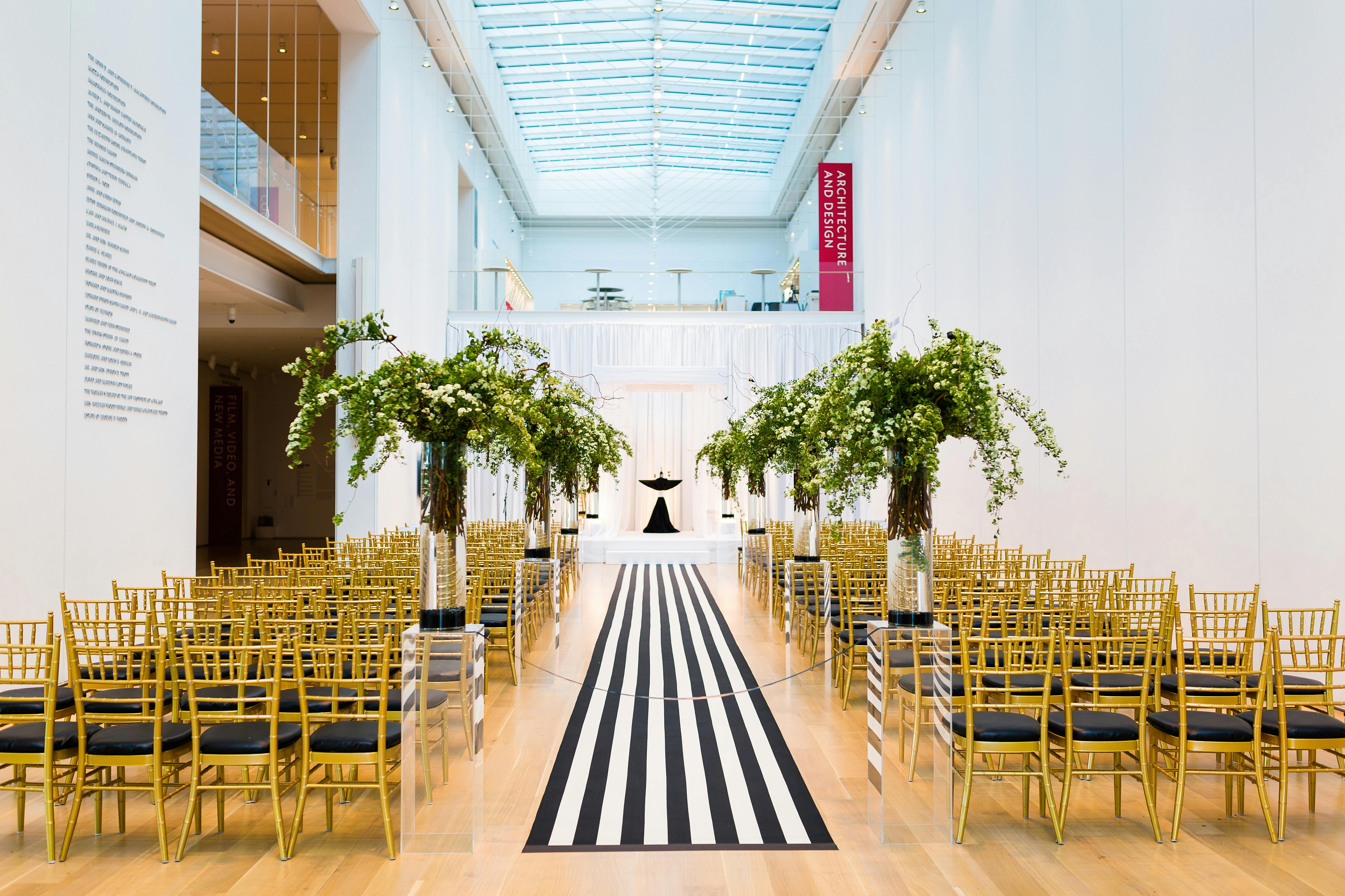 Chic modern wedding with black and white pin stripe aisle decor | PartySlate