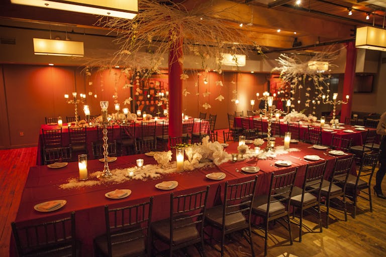 Bright red themed event space with long tables in Chicago | PartySlate