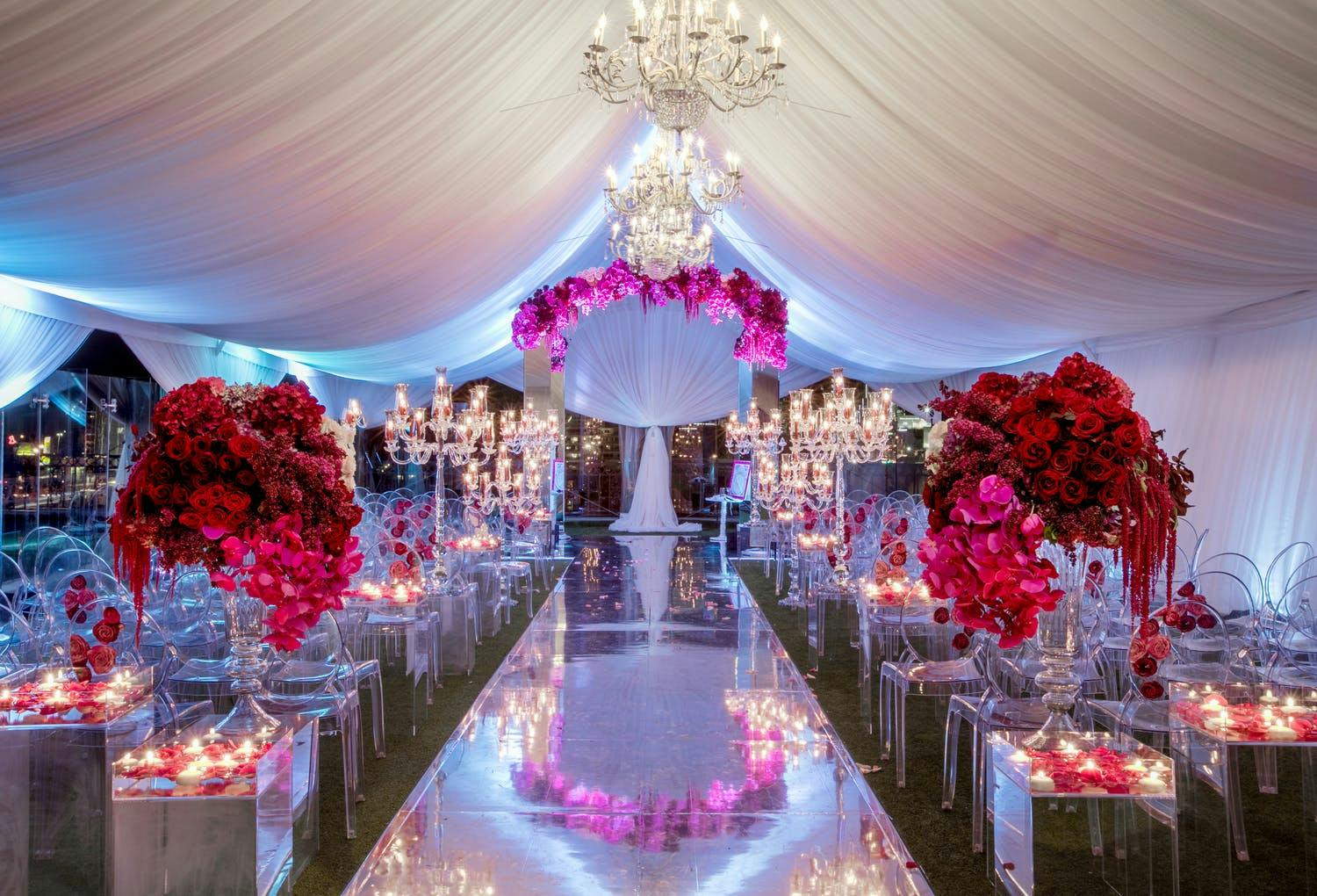 White and red floral tented wedding with floating candle lighting | PartySlate