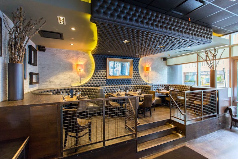 Elevated banquette area with plush gray tufted booths at Siena Tavern in Chicago, IL | PartySlate
