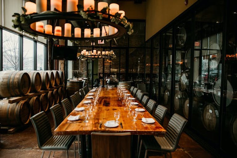 The Private Barrel Room at City Winery Chicago with oak barrels and a long wood table | PartySlate