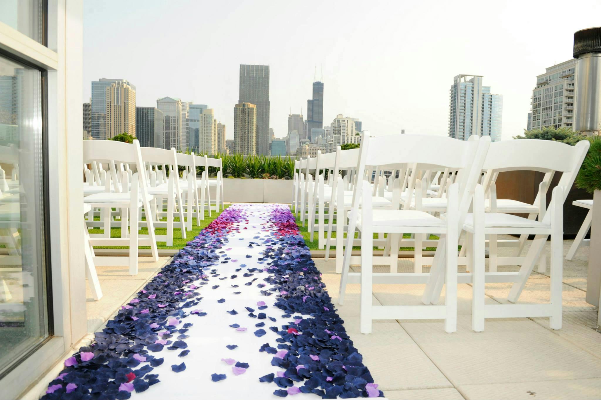 Ombre rose petal wedding aisle décor at surprise rooftop wedding | PartySlate