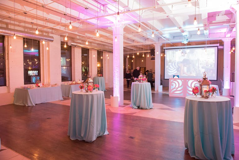 An open event space in Chicago for your sweet sixteen includes high tables for eating around and hanging industrial lights | PartySlate