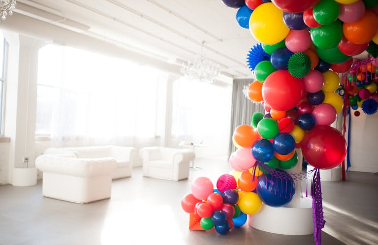 colorful sweet sixteen birthday balloon installation in white room in Chicago | PartySlate